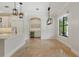 Bright kitchen and dining area with white cabinets, counter seating and stainless steel appliances at 1361 Palmer Ave., Winter Park, FL 32789