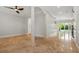 Spacious living room with polished floors, pillars, and sliding glass doors leading to the outdoor pool at 1361 Palmer Ave., Winter Park, FL 32789