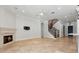 Spacious living area with a fireplace, tile flooring, and staircase leading to the upper level at 1361 Palmer Ave., Winter Park, FL 32789