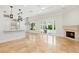 Bright and open living room featuring tan tile flooring, fireplace, and views of the outdoor area through glass doors at 1361 Palmer Ave., Winter Park, FL 32789