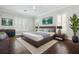 Cozy bedroom with a large bed, stylish decor, and shuttered windows for natural light and privacy at 1361 Palmer Ave., Winter Park, FL 32789