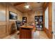 Private office with wood-paneled walls, built-in bookshelves, and a ceiling fan at 1361 Palmer Ave., Winter Park, FL 32789
