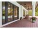 Covered patio featuring brick pavers, ceiling fans, and outdoor furniture with a view of the pool at 1361 Palmer Ave., Winter Park, FL 32789