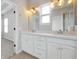 Double vanity in bathroom with ample counterspace and modern lighting at 14208 Shocklach Dr, Winter Garden, FL 34787