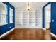 Elegant dining room with hardwood floors, built-in bookshelves, and modern chandelier at 14208 Shocklach Dr, Winter Garden, FL 34787