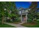 Charming two-story home featuring lush landscaping and a welcoming red front door at 14208 Shocklach Dr, Winter Garden, FL 34787