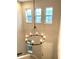 Bright foyer featuring a grand, wrought iron chandelier and abundant natural light from transom windows at 14208 Shocklach Dr, Winter Garden, FL 34787