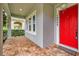 Inviting front porch with brick flooring and a vibrant red door at 14208 Shocklach Dr, Winter Garden, FL 34787