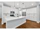 Elegant white kitchen featuring a central island and stainless steel appliances at 14208 Shocklach Dr, Winter Garden, FL 34787