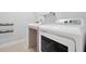 Laundry area with modern white appliances and tile flooring at 14208 Shocklach Dr, Winter Garden, FL 34787