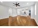 Bright, open-concept living area with hardwood floors and a ceiling fan at 14208 Shocklach Dr, Winter Garden, FL 34787