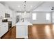 Open kitchen and living area with hardwood floors and modern stainless appliances at 14208 Shocklach Dr, Winter Garden, FL 34787