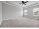 Large main bedroom with plush carpeting and tray ceiling detail at 14208 Shocklach Dr, Winter Garden, FL 34787