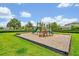 Community playground featuring a variety of play structures with a wood chip safety surface at 14208 Shocklach Dr, Winter Garden, FL 34787