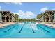 Beautiful community pool with lap lanes, lounge chairs, and covered seating areas for residents at 14208 Shocklach Dr, Winter Garden, FL 34787