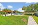Outdoor community pool with a covered pavilion, lush landscaping, and lounge chairs at 14208 Shocklach Dr, Winter Garden, FL 34787