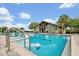 Community pool featuring lap lanes, an open-air pavilion, and poolside lounge chairs with stairs at 14208 Shocklach Dr, Winter Garden, FL 34787