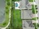 An aerial view showcases a beautiful backyard with a pool, lush green lawn, and privacy trees by the lake at 14516 Sunbridge Cir, Winter Garden, FL 34787