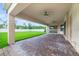 Spacious covered back patio features a brick paver floor, ceiling fans, and a beautiful view of the backyard at 14516 Sunbridge Cir, Winter Garden, FL 34787