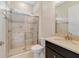 Bright bathroom featuring a glass-enclosed shower, updated fixtures, and a granite vanity top at 14516 Sunbridge Cir, Winter Garden, FL 34787