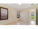 Bedroom with tile floors, plantation shutters, and a glass door leading to the outside at 14516 Sunbridge Cir, Winter Garden, FL 34787