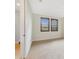Bare bedroom leading to bathroom with carpeted floors, dark wood shutters and fresh paint at 14516 Sunbridge Cir, Winter Garden, FL 34787