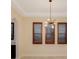 Dining room featuring contemporary lighting, plantation shutters, and neutral paint at 14516 Sunbridge Cir, Winter Garden, FL 34787
