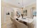 Elegant dining room featuring a marble table, modern chandelier, and arched doorways at 14516 Sunbridge Cir, Winter Garden, FL 34787