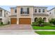 Stunning home featuring a three-car garage, balcony, arched entryways and brick paved driveway at 14516 Sunbridge Cir, Winter Garden, FL 34787