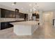 Spacious kitchen featuring a large island, dark cabinets, and stainless steel appliances at 14516 Sunbridge Cir, Winter Garden, FL 34787