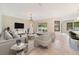 Spacious living room featuring tile floors, comfortable seating, and sliding doors to the patio at 14516 Sunbridge Cir, Winter Garden, FL 34787