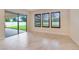 Bright living space featuring tile floors, large windows, and sliding glass doors to a covered patio at 14516 Sunbridge Cir, Winter Garden, FL 34787