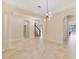 Open living room with tile flooring, modern chandelier, and arched doorways at 14516 Sunbridge Cir, Winter Garden, FL 34787