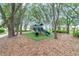 Neighborhood playground features a play structure with slides, a tunnel and is surrounded by mature trees at 14516 Sunbridge Cir, Winter Garden, FL 34787