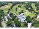 An aerial view showcasing the Rio Pinar Golf & Country Club, complete with mature trees and ample parking at 1529 Ensenada Dr, Orlando, FL 32825