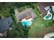 Aerial view showcasing a home with a pool, spacious yard, and mature trees at 1529 Ensenada Dr, Orlando, FL 32825