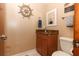 Cozy half bath features updated fixtures, vanity with granite countertop, and decorative nautical-themed accents at 1529 Ensenada Dr, Orlando, FL 32825
