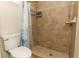 Bathroom features tiled shower with decorative accents, tiled flooring, and a toilet at 1529 Ensenada Dr, Orlando, FL 32825
