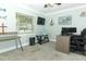 Bright bedroom offers a comfortable workspace, featuring a large window and neutral décor at 1529 Ensenada Dr, Orlando, FL 32825