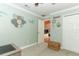 Bedroom with light green walls, white trim, and decor leads to the main living space at 1529 Ensenada Dr, Orlando, FL 32825