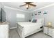Bedroom boasts a ceiling fan, neutral walls, window, a dresser, and a well-lit night stand at 1529 Ensenada Dr, Orlando, FL 32825