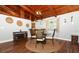 Charming dining area featuring wood-beamed ceilings and a stylish round table with seating for four at 1529 Ensenada Dr, Orlando, FL 32825