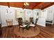 Elegant dining room with a glass-top table, wood flooring, and natural light, ideal for entertaining guests at 1529 Ensenada Dr, Orlando, FL 32825