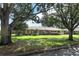 Charming single-story home with a well-manicured lawn and mature trees at 1529 Ensenada Dr, Orlando, FL 32825