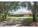 Charming home with mature trees, manicured lawn, and inviting curb appeal at 1529 Ensenada Dr, Orlando, FL 32825