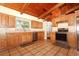 Charming kitchen featuring custom wood cabinets, modern stainless steel appliances, and tile flooring at 1529 Ensenada Dr, Orlando, FL 32825