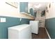Efficient laundry room with sleek washer, dryer, freezer, cabinets, and stylish decor at 1529 Ensenada Dr, Orlando, FL 32825
