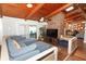 Open-concept living room featuring exposed beams, wood floors, and ample natural light at 1529 Ensenada Dr, Orlando, FL 32825