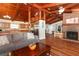 Inviting living room with exposed wood beams, hardwood floors and a cozy fireplace at 1529 Ensenada Dr, Orlando, FL 32825
