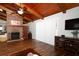Spacious living room boasts a brick fireplace, wood-beamed ceilings, and ample natural light at 1529 Ensenada Dr, Orlando, FL 32825
